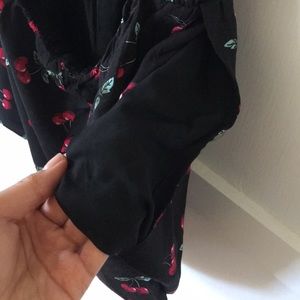 Love + Harmony Pants - Black and red cherry printer romper. Love + Harmony Pants - Black and red cherry printer romper.
